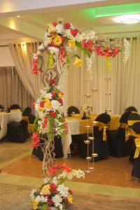 a pole with flowers on it in a room at Capital Regency in Kandy