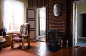 a living room with a chair and a fireplace at Skanckegårdene AS in Røros