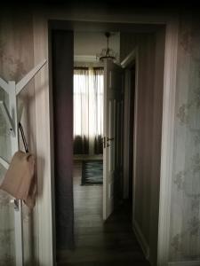 a hallway with a door leading into a room at Hotell Floras Trädgård in Öregrund