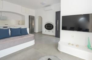 a living room with a couch and a flat screen tv at Shape-Infinity in Kalymnos