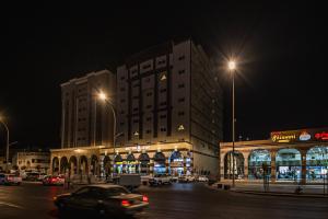 a building on a city street at night at فندق غالية احد in Al Madinah