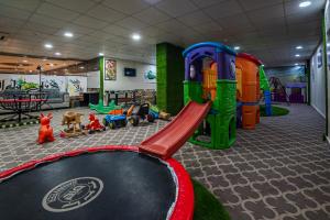 a play room with a playground with a slide at Ghalyt Ohud in Al Madinah
