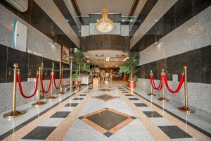 a lobby with red ribbon barriers in a building at فندق غالية احد in Al Madinah