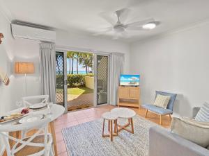 a living room with a couch and a table and chairs at Sails on Horseshoe Apartment 5 in Horseshoe Bay
