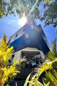 un edificio con el sol brillando en él en Cleo Business Hotel Walikota Mustajab City Center, en Surabaya