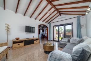 a living room with a couch and a tv at VV Makita by HH in Playa Blanca