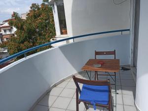 a small table and chairs on a balcony with a window at Διαμέρισμα 110 Μ στον Λαγκαδά in Lagadas