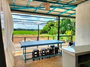 a blue table in a room with a view at De Hampar Homestay in Kampong Merbok