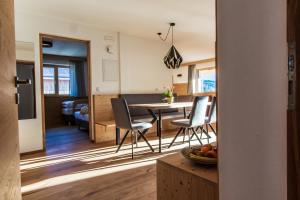 a kitchen and dining room with a table and chairs at Kieserhof Apartment Alm in Terento