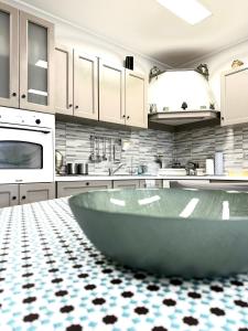 a kitchen with a large tub in the middle of it at Le Mandorle Apartment in Belpasso +4 photos