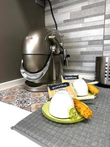 a plate of food on a counter next to a mixer at Le Mandorle Apartment in Belpasso