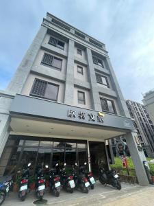 a building with motorcycles parked in front of it at Otter Hotel in Jinhu