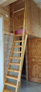 a wooden bunk bed with stairs in a room at Montfort Weekend in Ma‘alot