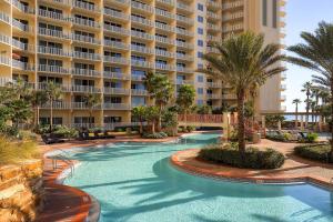 a swimming pool in front of a large building at Shores of Panama by Panhandle Getaways in Panama City Beach