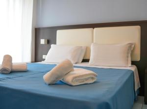 Postel nebo postele na pokoji v ubytování Hotel Lido