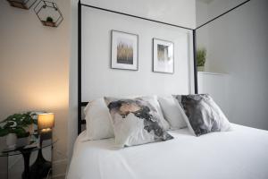 a bed with white sheets and pillows in a bedroom at Chelmsford House By Horizon Stays in Darlington