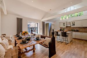 a large living room with a table and a kitchen at The Willows by Bloom Stays in Ash