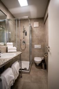 a bathroom with a shower and a sink and a toilet at AP Hotel Mannheim Viernheim in Viernheim