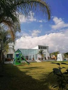a playground with a slide in front of a building at Casa Blanca Tenextepec Atlixco. 