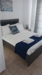 a bed with two towels on top of it at Quattro Beachfront Sea View Ap 53 in Larnaka