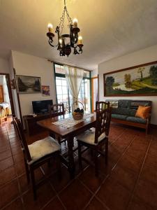 a dining room with a table and chairs and a couch at CASA COREA IV in Puntagorda