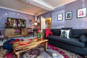 a living room with a couch and a table at The House of Black & White in Great Torrington