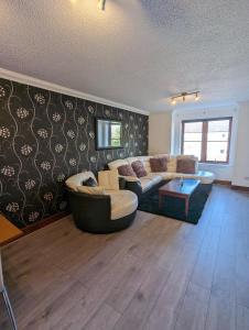 a living room with a couch and a table at Superb 2 Bedroom Flat Tillicoultry in Tillicoultry