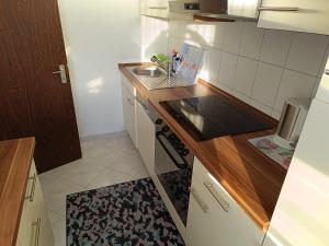 a small kitchen with a sink and a stove at Ferienwohnung zum Glück in Bad Kissingen +6 photos