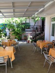 an empty patio with tables and chairs in a restaurant at Room in Sukosan with balcony, air conditioning, WiFi 5188-7 in Sukošan
