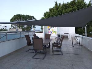 een patio met een tafel en stoelen op een dak bij Casa Blanca Tenextepec Atlixco. 