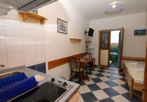 a kitchen with a stove and a counter top at Studio apartment in Sucuraj with sea view, balcony, air conditioning, WiFi 3560-3 in Sućuraj