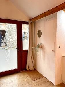 a room with a door and a window at Four à pain in Sprimont