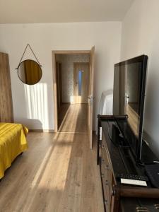 a living room with a flat screen tv on a dresser at Sunny House Two in Bratislava