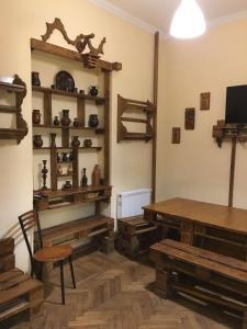 a room with a table and wooden tables and shelves at For Daily Rent in Tbilisi City