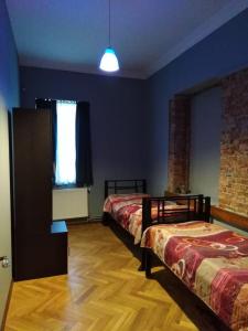 a room with two beds and a window at For Daily Rent in Tbilisi City