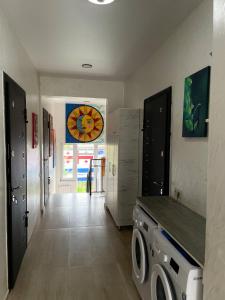 a laundry room with a washing machine and a window at Sun and Moon in Batumi