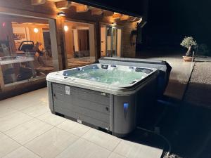 a hot tub in the middle of a patio at Chalet HerMes arT in Idrija