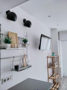 a room with white walls and shelves with plants at GLP RISCAL 2 in Alicante