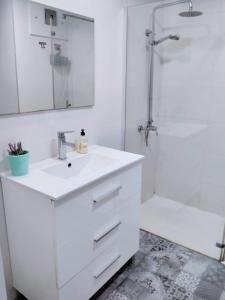 a white bathroom with a sink and a shower at GLP RISCAL 2 in Alicante