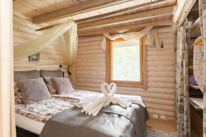 a bedroom with a bed in a log cabin at Cottage with Hot tub and Sauna in Uurainen