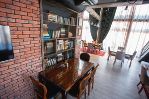 a living room with a brick wall and a table and chairs at Boutique Hotel Baku in Baku