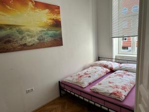 Bett in einem Zimmer mit Wandgemälde in der Unterkunft City Apartment in Wien