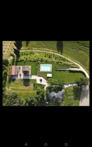 una vista aérea de una casa en un campo verde en Agriturismo Colle Casini Cortesi, en Caldarola