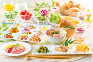 a table with plates of food and bowls of food at Ooedo Onsen Monogatari Premium Ikaho in Shibukawa