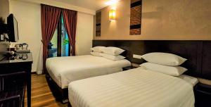 Postel nebo postele na pokoji v ubytování Hotel Richbaliz Selayang