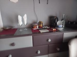 a dresser with a counter top with glasses on it at The Boat House BED ONLY NO BREAKFAST in Aultbea