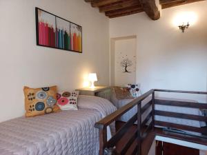 1 dormitorio con 1 cama en una habitación con escalera en La casa dei nonni, en Lucca