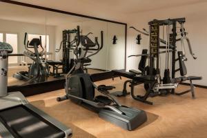 a gym with several exercise bikes and a mirror at Almazino, Almaza Bay in Mājid Abū Zayd