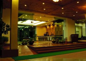 a lobby of a building with potted plants in it at Mastiff Grand Manali Resort in Manāli