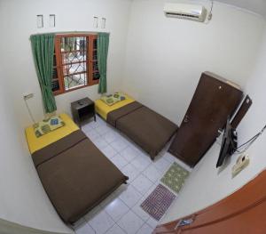 Ένα ή περισσότερα κρεβάτια σε δωμάτιο στο Green Purwosari Guest House Jogja